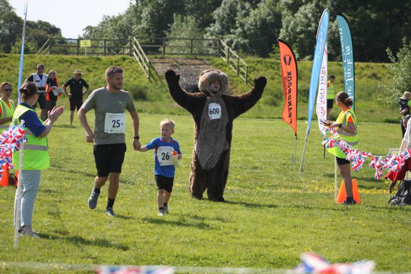 A finish line photo with Derek the Otter